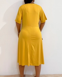 Detail of a dark yellow short-sleeve dress showing the crew neck and A-line silhouette