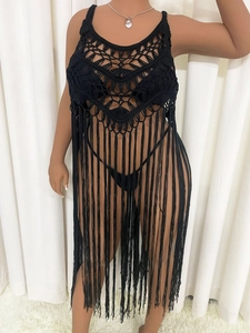Detail view of black crochet hollow-out design with long tassels on a beach cover-up dress