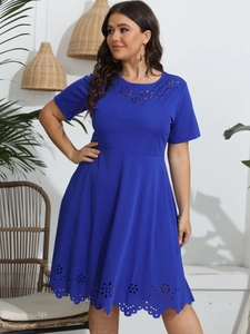 Detail of laser-cut floral hollow patterns on the round neck of a blue plus size dress
