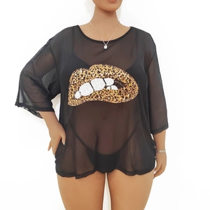 Detail of leopard sequin lip patch on black semi-transparent mesh top for women