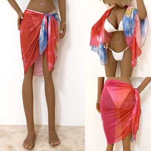 Detailed view of colorful tie-dye beach wrap showing sheer mesh fabric and versatile styling