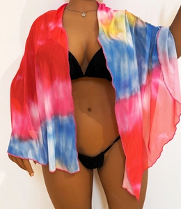 Detail of colorful tie-dye mesh beach cover-up with vibrant pink stitched edge