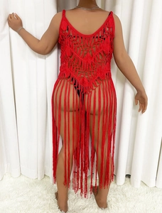 Macro view of red crochet beach cover-up featuring fringe details and geometric back pattern