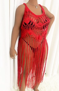 Detail of red crochet tassel cover-up featuring intricate hollow knit floral patterns