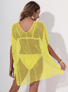 Macro view of bright yellow hollow mesh fabric on a sexy loose beach bikini cover-up
