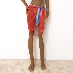 Detailed close-up of vibrant tie-dye sarong beach skirt with side tie waist and wrap design