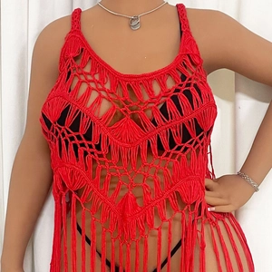 Close-up of red crochet knit beach cover-up featuring intricate geometric hollow patterns