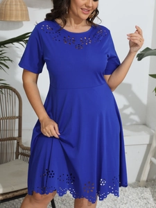 Detail of laser-cut floral hollow patterns on a royal blue crewneck short sleeve dress