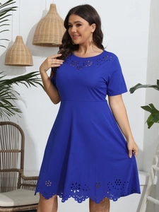 Close-up of royal blue plus size dress with laser-cut hollow floral details and A-line cut