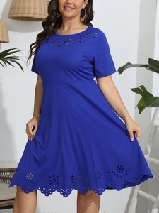 Detail of laser-cut floral pattern on royal blue short sleeve plus size dress