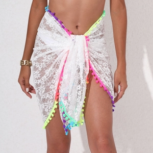 White lace beach sarong wrap featuring colorful pom-poms and sheer floral texture