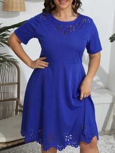 Detail showing laser-cut floral patterns on dark blue round neck dress waist