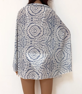Detail view of semi-transparent polka dot beach cover-up with lightweight fabric