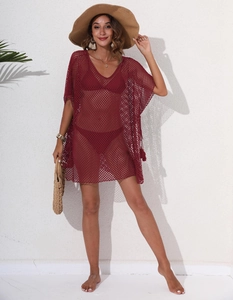 Detail of burgundy crochet mesh beach cover-up with V-neckline and fringe accents