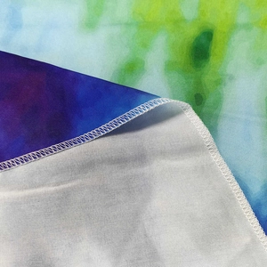 Tie-dye gradient round beach towel with fine edge stitching and watercolor print detail