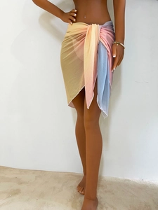 Detail of colorful gradient tie-dye beach sarong with light mesh fabric and tie-waist design