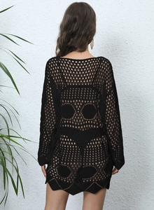Detail of crochet beach cover-up featuring a large skull pattern on the back