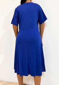 Rear view of a royal blue short sleeve midi dress with round neck and A-line silhouette