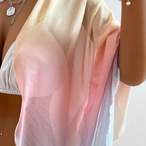 Detail of sheer tie-dye gradient sarong featuring delicate edge stitching and mesh texture