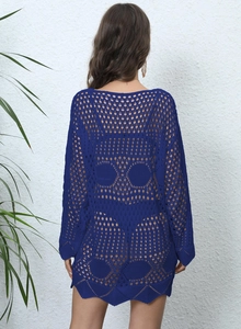 Detail of royal blue crochet beach cover-up featuring a skull pattern on the back