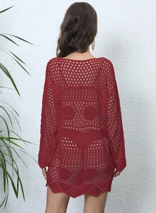 Detail of burgundy crochet beach cover-up showing intricate knit patterns and back design