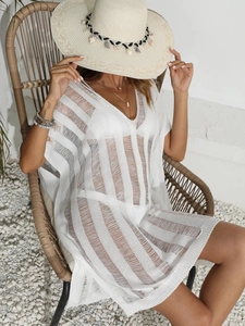 Detail of white hollow-out crochet beach cover-up with textured vertical knit patterns