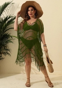 Detail of dark green crochet beach cover-up featuring mesh texture and long fringe hemline