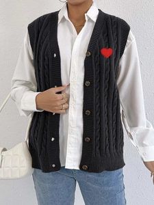 Black cable knit vest cardigan with V-neck and red heart embroidery patch detail