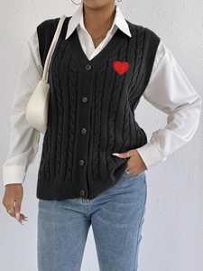 Detailed knit texture and red heart embroidery on a black V-neck button-up vest