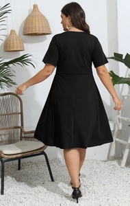 Detail of plus size short sleeve black A-line dress showing back silhouette and fabric