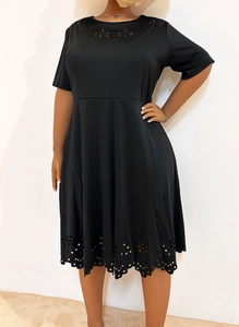 Detail of hollow floral patterns on the neckline and hem of the black plus size dress