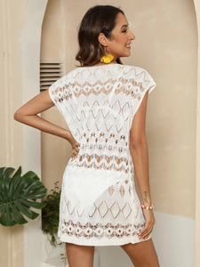 Detail of white hollow-out crochet beach cover-up with geometric knit and side split