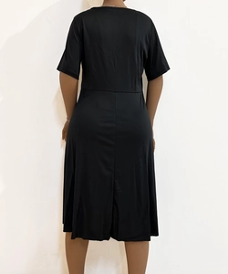 Detailed back view of a slim-fit black short sleeve dress with waist seam design