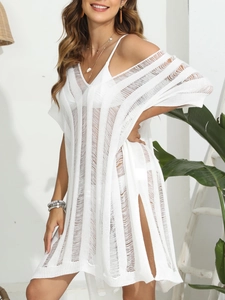 Detailed knit texture of a white crochet beach cover-up with stylish side slits