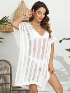 Close-up of white hollow-out knit beach cover-up with V-neck and vertical stripe details