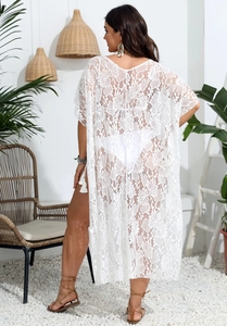Detailed view of floral lace beach cover-up with tassel trim and side slit detail
