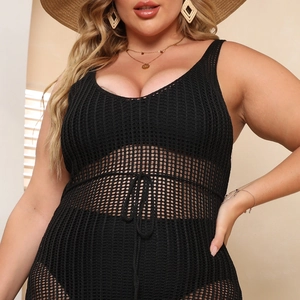Detail of black crochet beach cover-up featuring mesh texture and drawstring waist ties