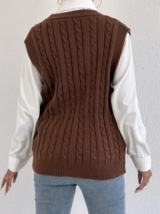 Back view of a brown cable knit vest layered over a white shirt and blue denim jeans