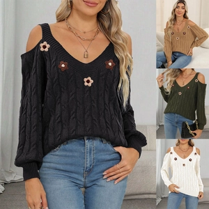 Detail view of cable knit sweater with off-shoulder design and 3D floral appliqués