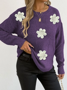 Detail of 3D white floral applique on purple knit sweater with ribbed textures