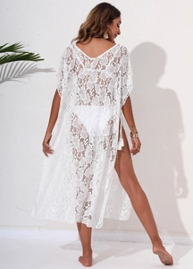 Detailed back view of a white floral lace beach cover-up dress with tassel tie details