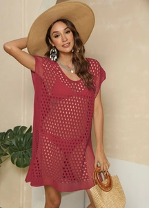 Detail of red hollow-out crochet beach cover-up showing knitted texture and split design