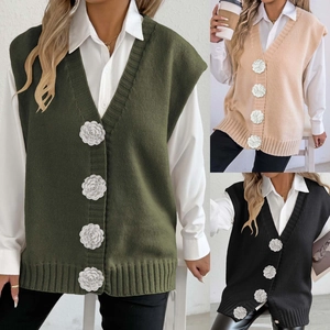 Detailed view of women's knit vest featuring 3D flower buttons and casual V-neck design