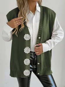 Detail of olive green knit vest featuring white 3D crochet rose flowers and V-neckline