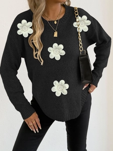 Women's black knit sweater with 3D white floral appliques and beaded centers on shoulder