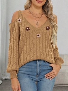 Close-up of cable-knit texture and 3D floral accents on this khaki off-shoulder sweater