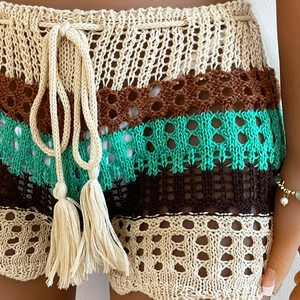 Close-up of bohemian crochet shorts featuring woven textures and tassel drawstring ties