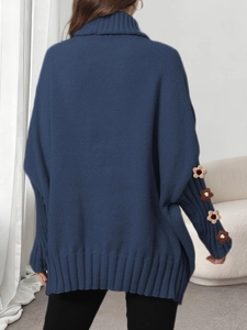 Detail of navy oversized turtleneck sweater with white crochet flowers on sleeves back view