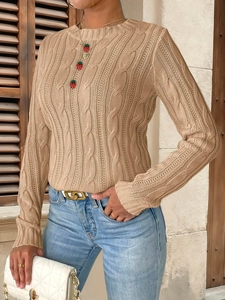 Close-up detail of light camel cable knit sweater with retro texture and ribbed edges