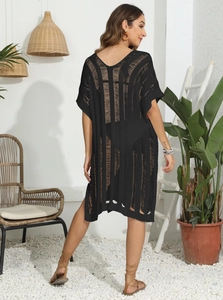 Detail of black hollow-out knit beach cover-up featuring vertical stripes and V-back design